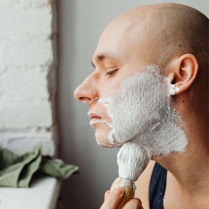 homme chauve se rase  avec blaireau de rasage  doux